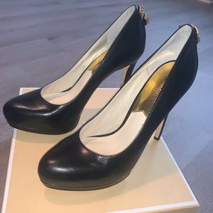 Black closed toe Michael Kors heels.